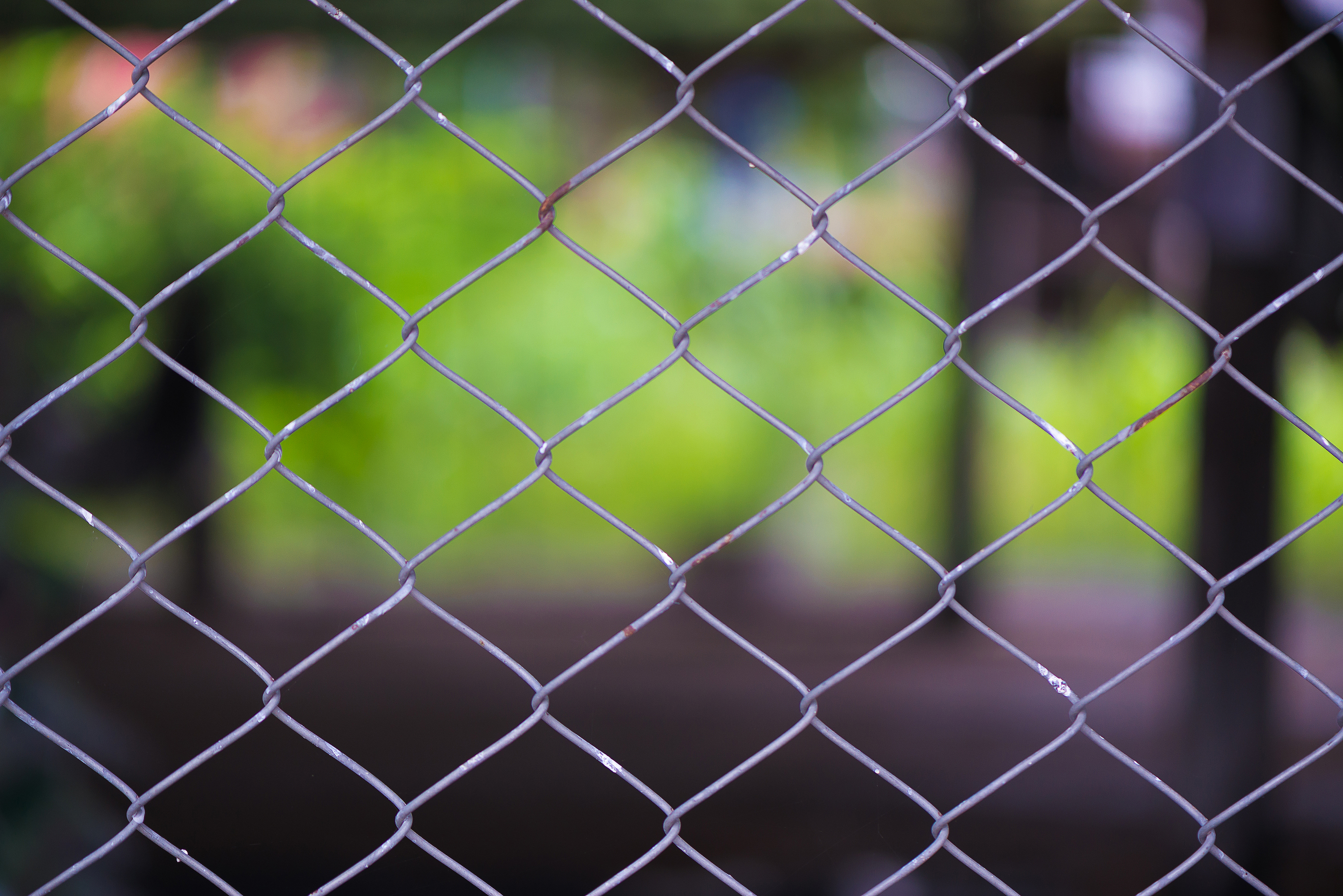 Rusty Chain Link Fence Of Steel Netting On Blur Background.